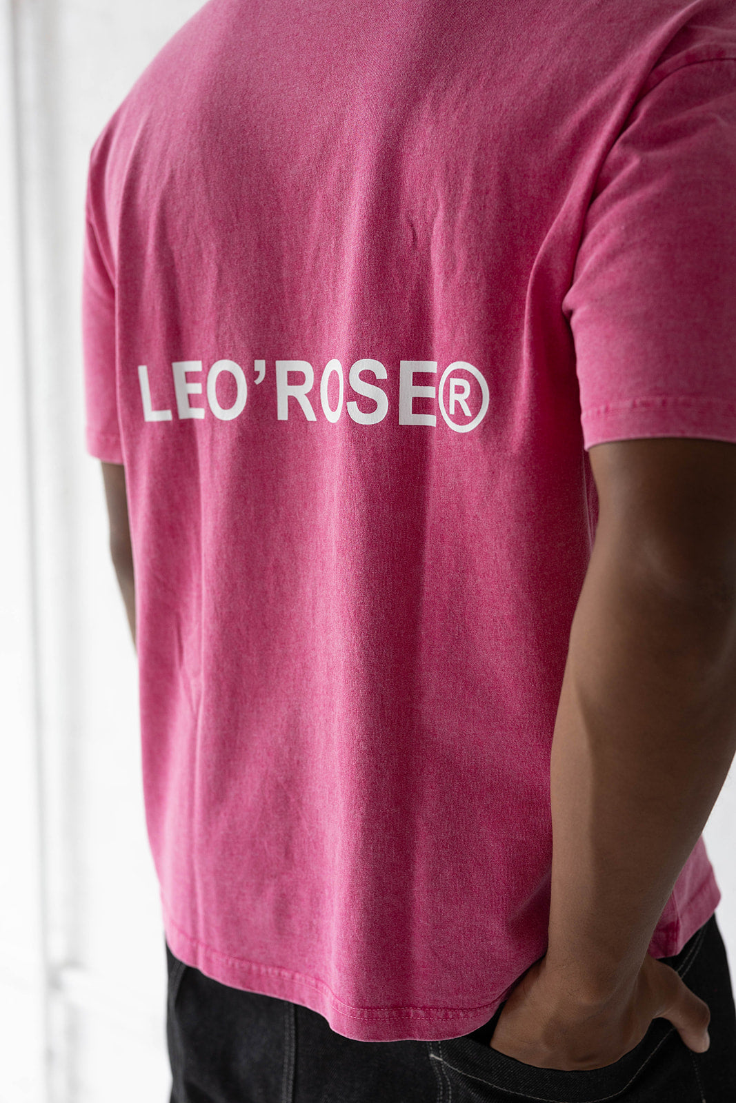 Man in a pink LEO'ROSE tee